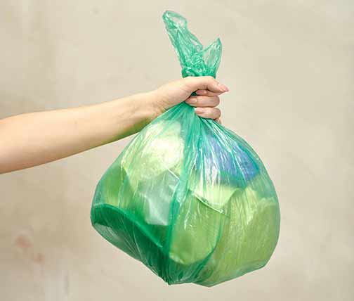 Woman holding a garbage bag