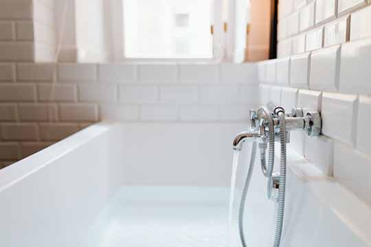 A close-up picture of a faucet in a bath