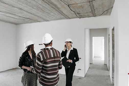 Three people inspecting a house before relocating to an older Chicago home.