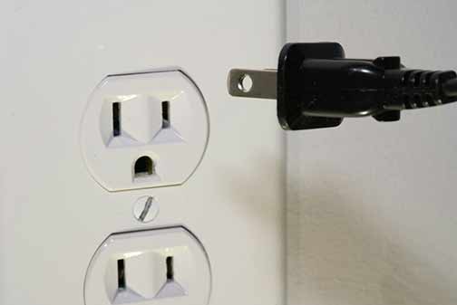 Close-up of an electrical outlet looking like a surprised face.