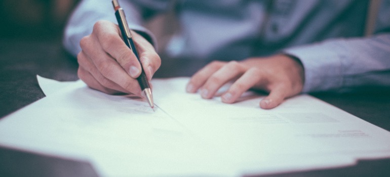 A person signing documents.