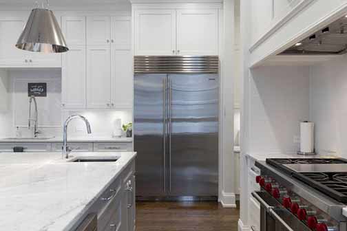 A kitchen with large counters and bulky appliances.