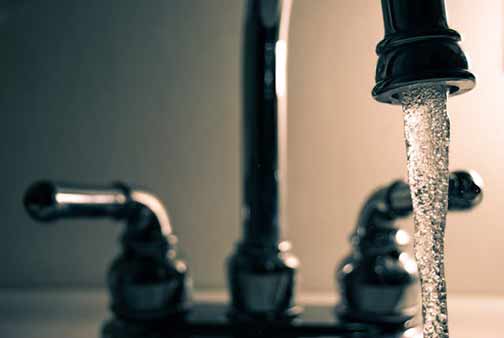 Water flowing from a kitchen faucet