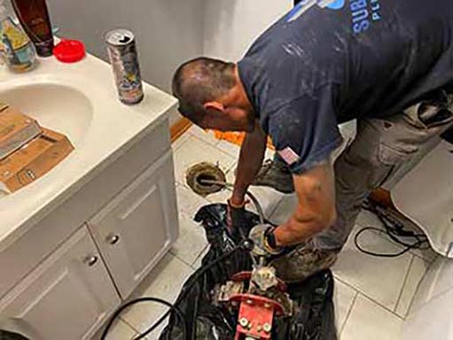 a berwyn emergency plumber unclogging a drain.