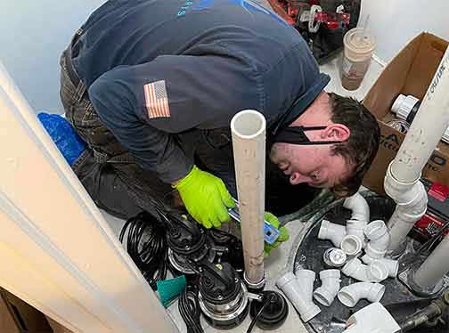 a plumber replacing a sump pump in chicago.