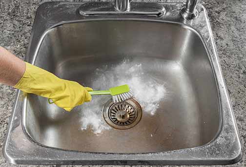 regularly clean your kitchen sink to avoid a stench.