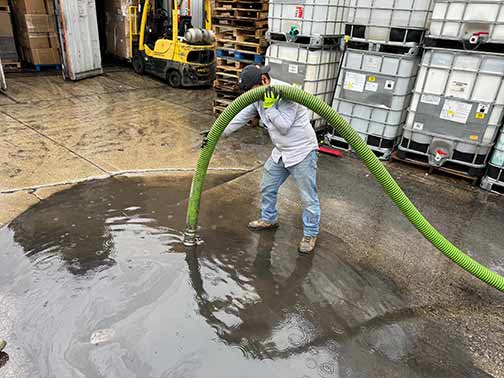 a plumber performing a commercial drain cleaning service.