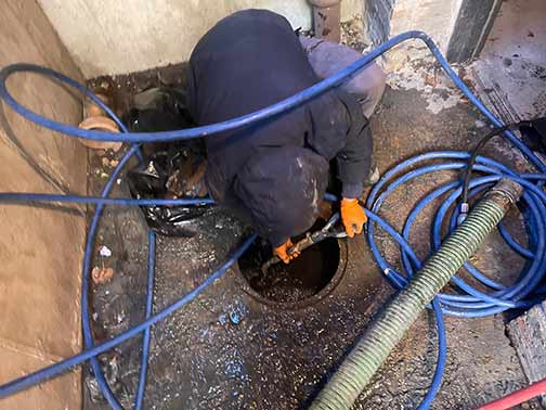 a plumber performing a commercial hydro jetting.