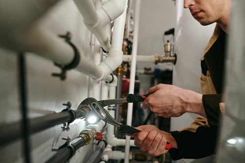 a commercial plumber making repairs