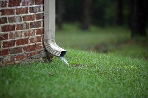 a home in need of downspout extensions.