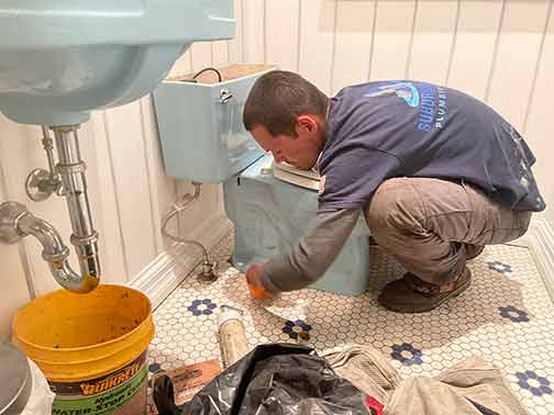 an emergency plumber performing a repair.