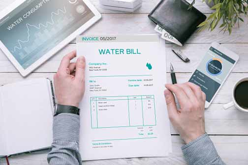 a man reading his higher than usual water bill.