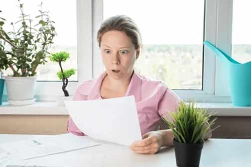 a woman shocked at her high water bill.