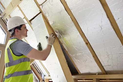 a contractor installing insulation to a home.