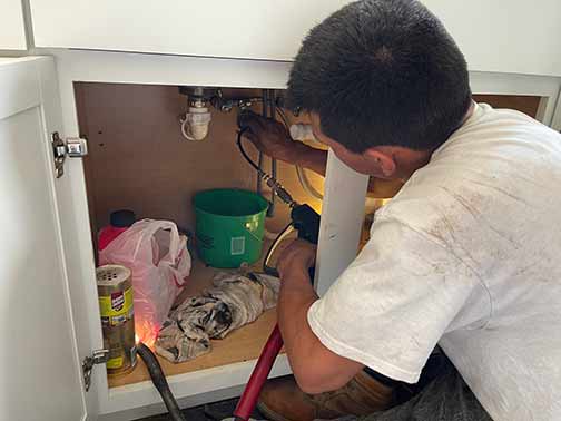 a plumber performing a hot water hydro jetting.