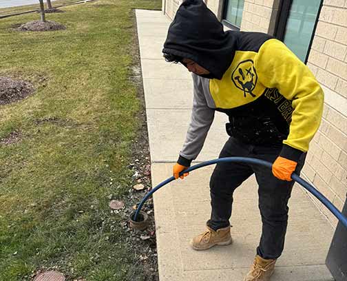 a plumber performing a hydro jetting service for a business in chicago.