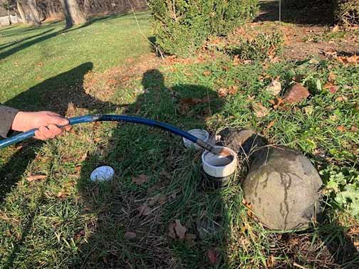 a professional plumber performing a hydro jetting service