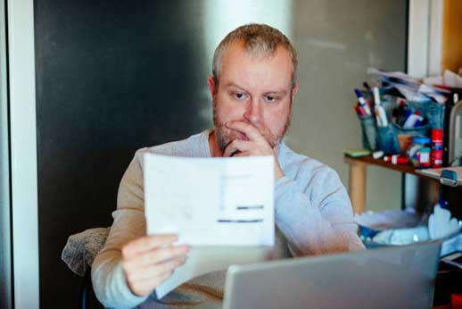 a man reading his high illinois sewer bill.