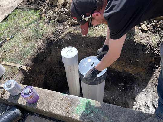 a plumber installing a sewer cleanout in the city of chicago.