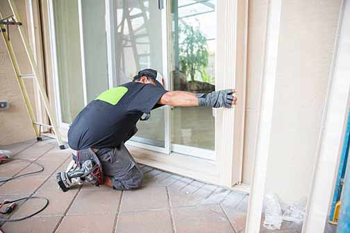 a contractor installing storm windows.