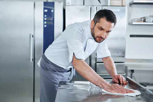 a restaurant employee practicing proper kitchen hygiene.