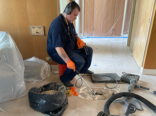 a plumber performing a leak detection in chicago.