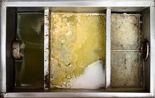 an overflowing restaurant grease trap