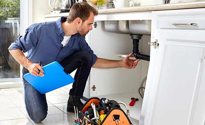 a plumber performing an inspection.