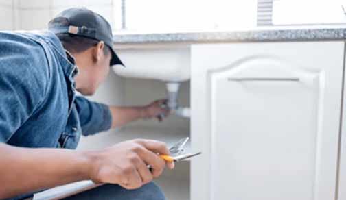 a plumber doing a plumbing inspection