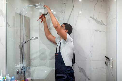 a professional plumber making shower repairs