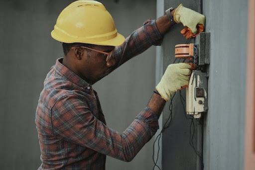 a plumber adjusting proper voltage.