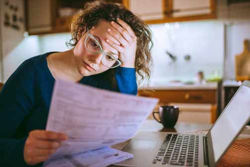 a woman reading a plumbing estimate.