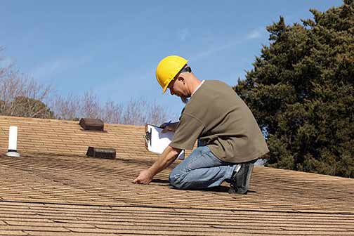 a roofing contractor performing an inspection