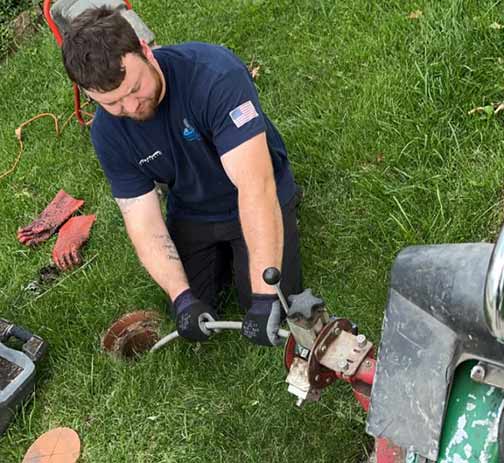 a plumber performing a rooter service in chicago.