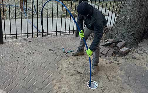 a plumber performing a sewer line cleaning known as hydro jetting.