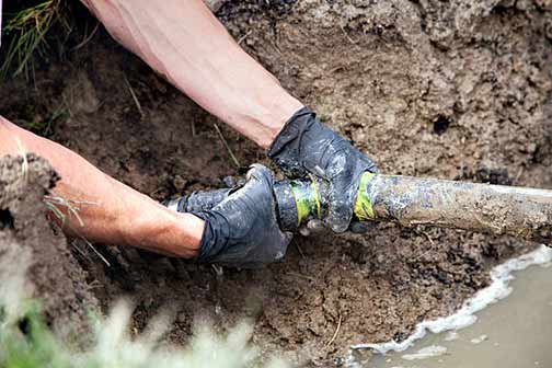 a plumber repairing a bad sewer line.