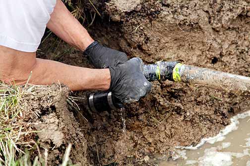 a plumber doing sewer system maintenance.