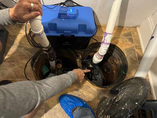 a plumber replacing a sump pump.