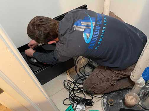 a sump pump specialist making a repair.