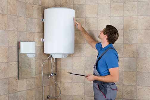 a plumber completing a tankless water heater installation.