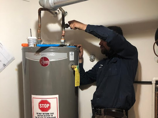 a professional plumber installing a water heater in chicago.