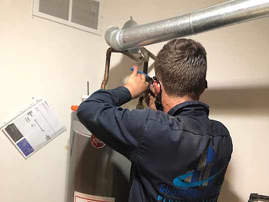 a plumber installing a water heater