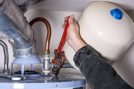 a plumber working on a water heater repair.