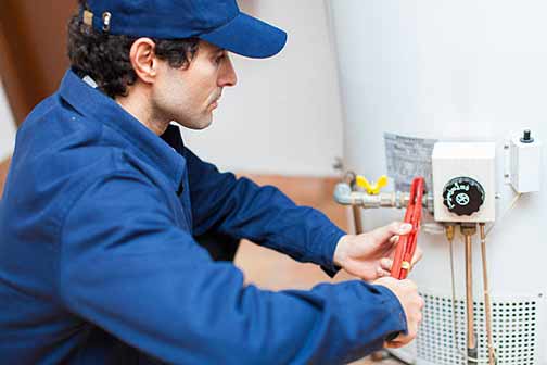 a plumber repairing a water heater.