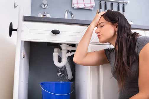 woman with a water leak in her bathroom.