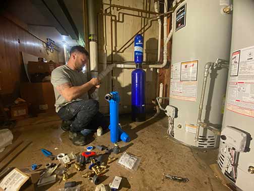 a plumber installing a water softener in chicago.