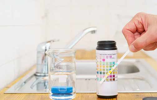 a person testing their water after a flood